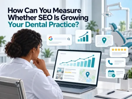 Person analyzing SEO growth metrics on laptop in dental office setting to measure dental practice success